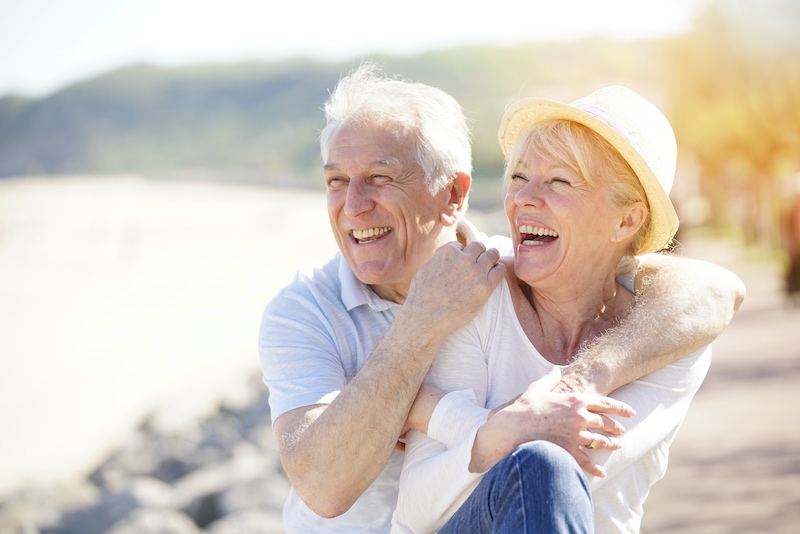 Senior couple having a great time seaside on sunny day