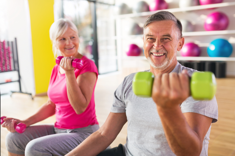 Senior couple exercising in gym