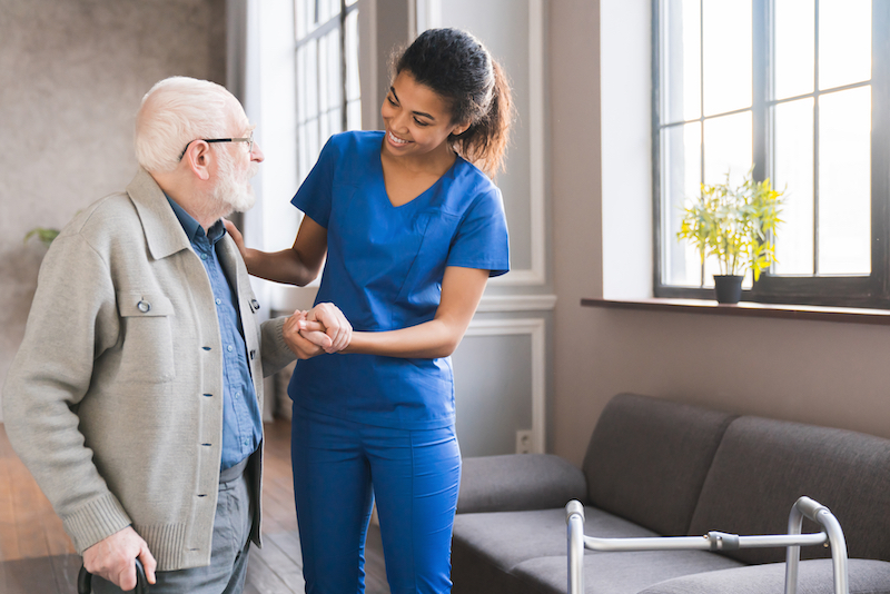 Young nurse helping senior man