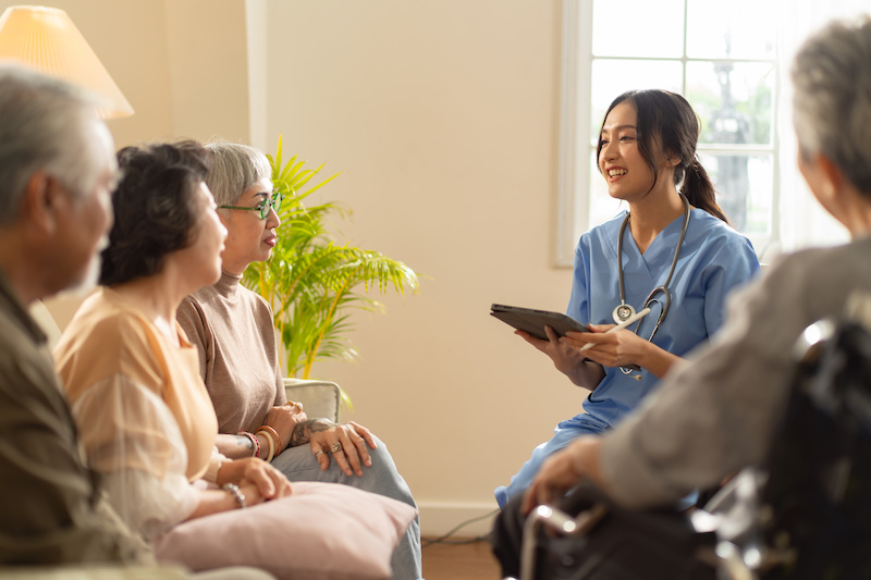 Group of seniors listening to the friendly nurse