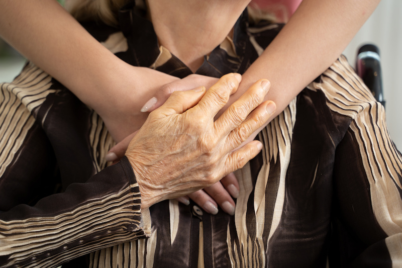 Female caregiver or nurse holding a seniors hand