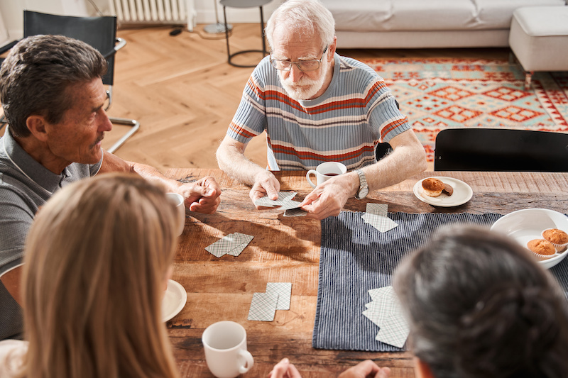 Seniors playing cards at assisted living home