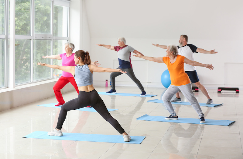 Seniors doing yoga at assisted living facility 