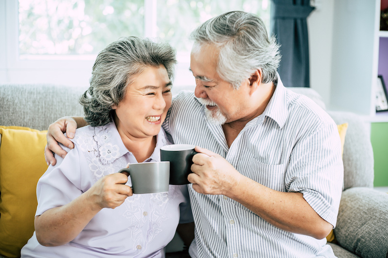 Elderly Couple Talking together and drinking coffee